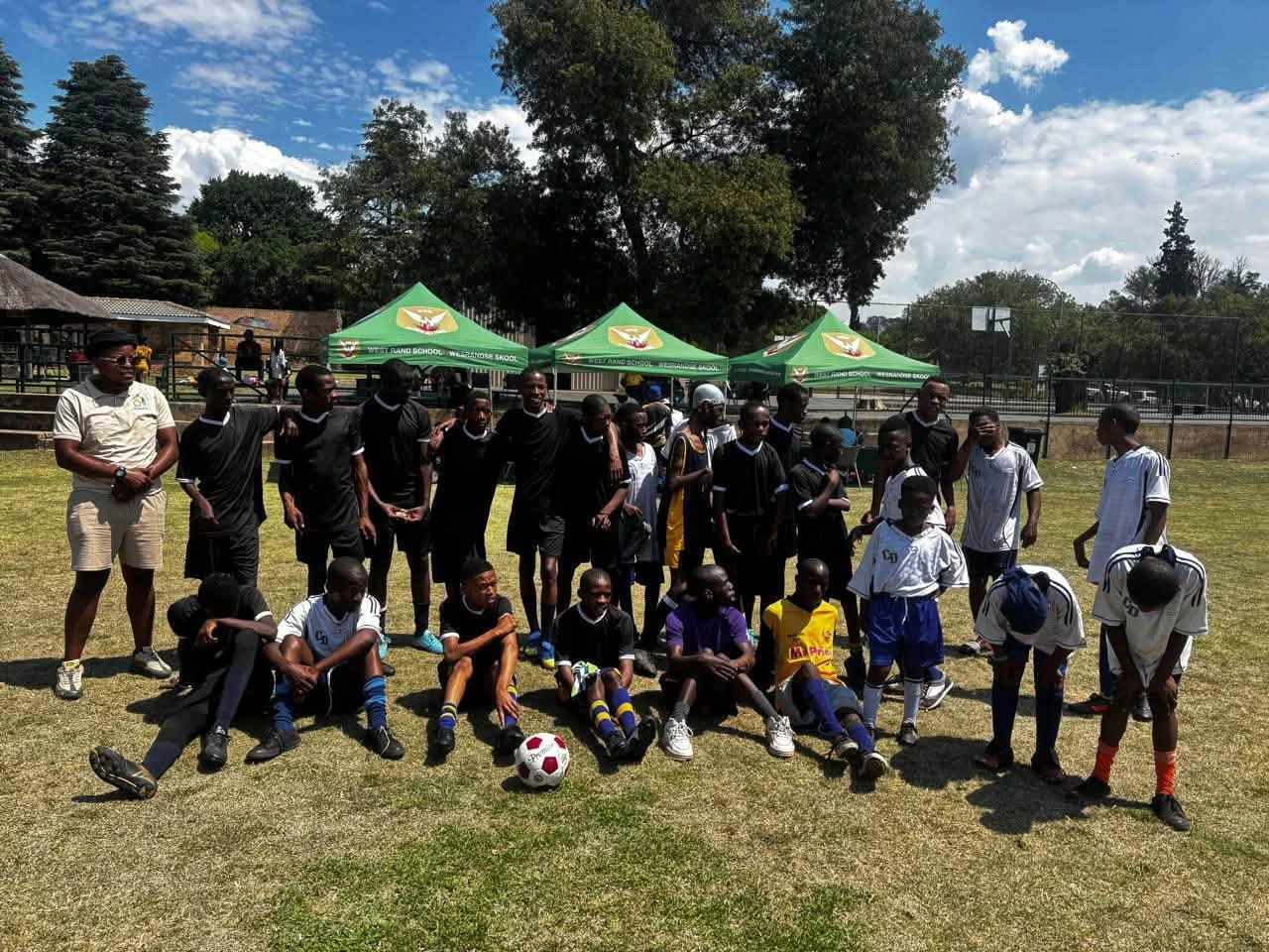 School soccer teams and coaches together on the field